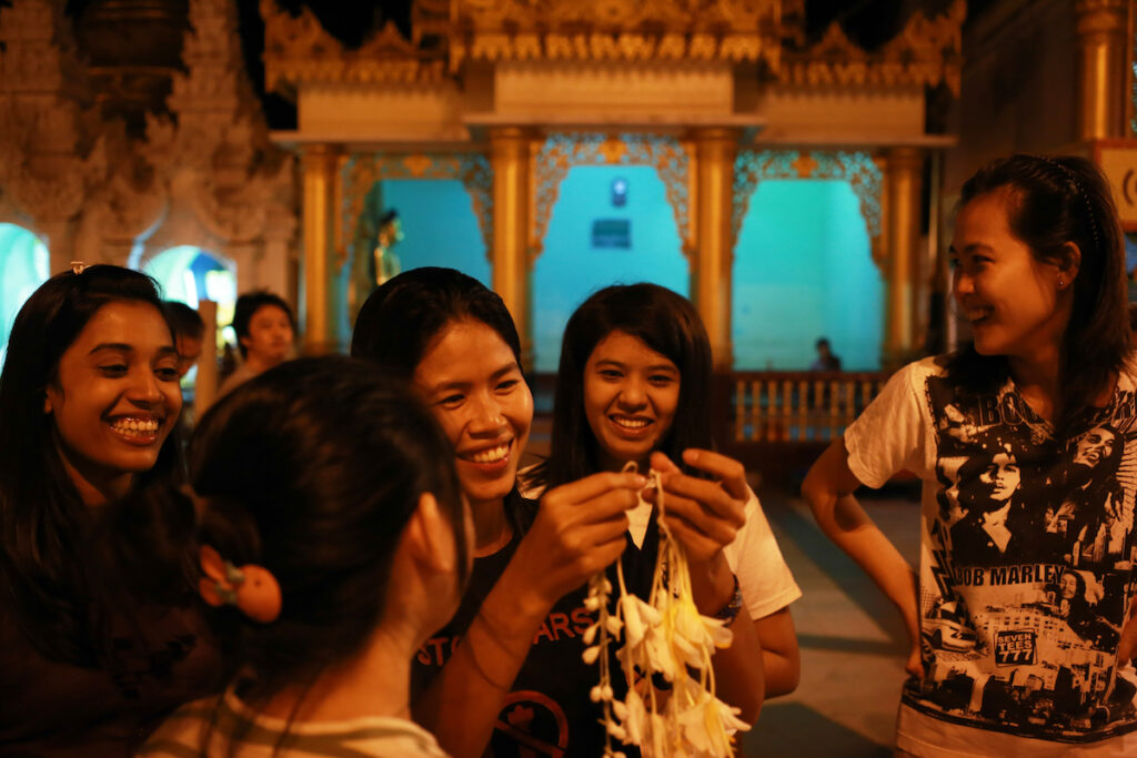 Thwe Thwe Oo (L, Christian), Kham Lao (2nd L, Buddhist), Aye Aye Yu (3rd L, Buddhist), Khin Zar Mon (4th L, Muslim) and Phway Phway (R, Christian) smile together as they chit chat on the platform of Shwedagon Pagoda.