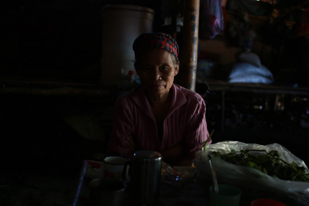 An elderly woman rests inside a tent in a camp for internally displaced people in Laiza.