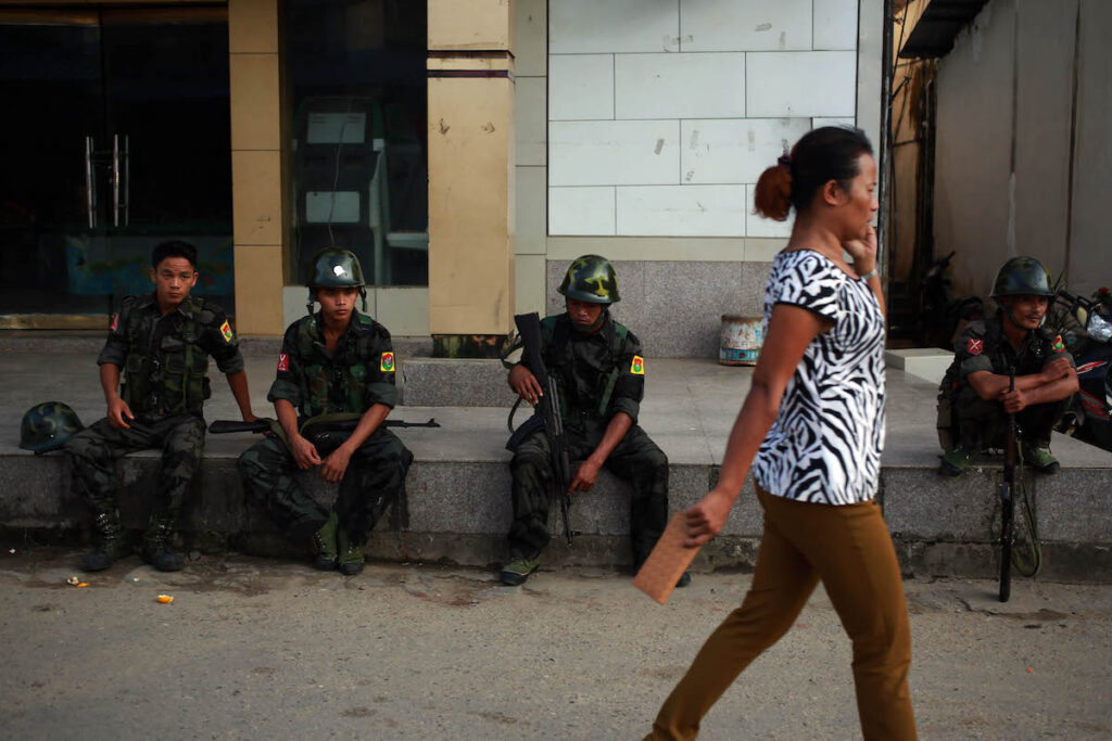 A KIA patrol takes a break on a street in Laiza.