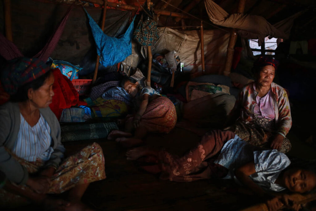 Elderly women rest inside a tent in IDP Camp in Laiza where over 4000 people evacuated from civil war.