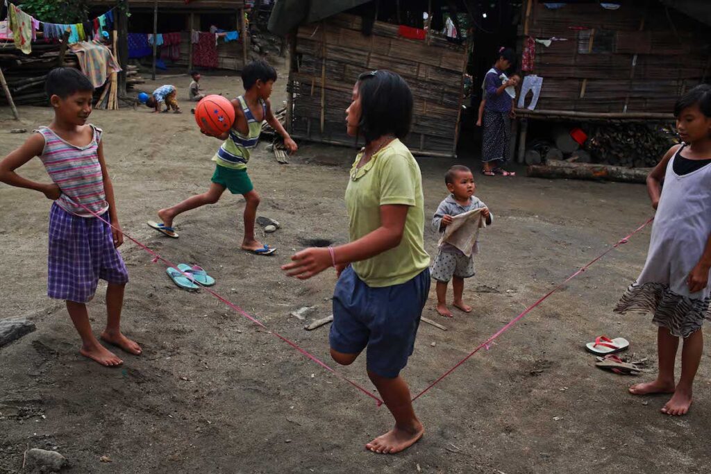 Children play in front of the tents in Je Yang IDP Camp in Kachin State.